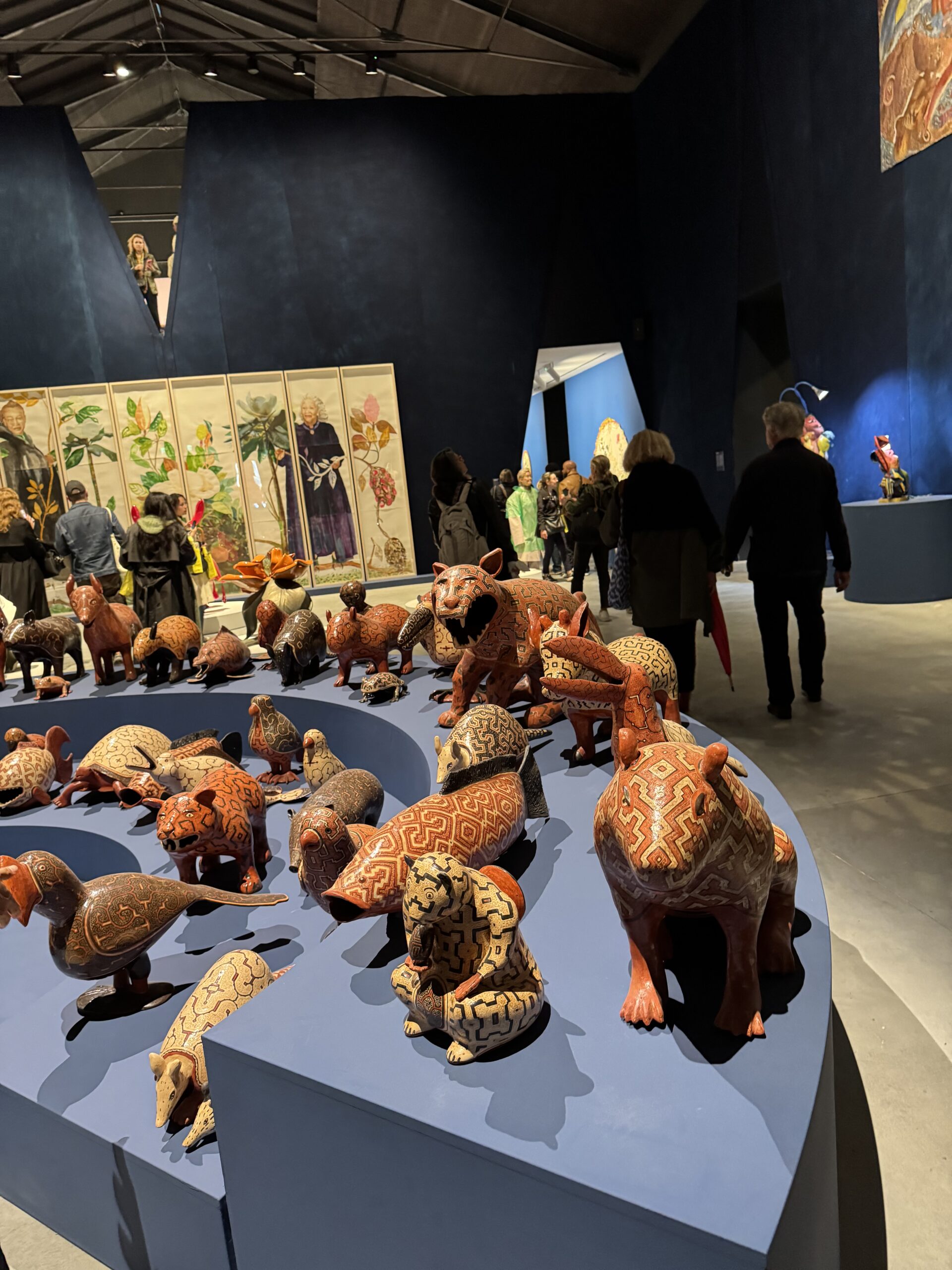 The Shrines Section Central Pavilion, Maria Magdelena Campos-Pons, Anatomy of the Magnolia Tree for Kouoh and Toni Morrison, 2026. Foreground, Cecilia Vasques Yui. The Council of the Mother Spirits of the Animals, 2022.