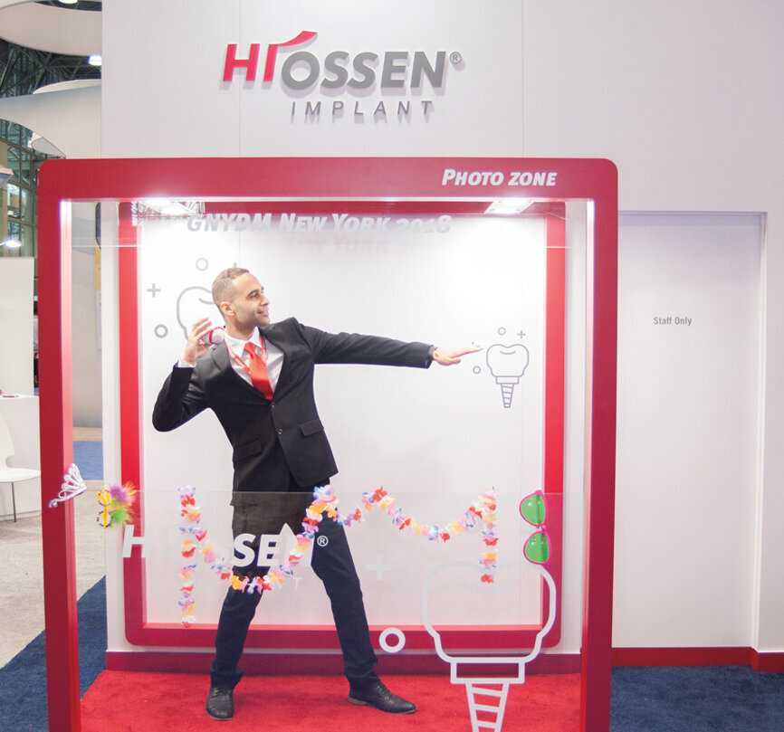 Eslam Elgamel of Hiossen Implant shows off his quarterbacking technique. (Photo: Jahmel Charles, Dental Tribune America)