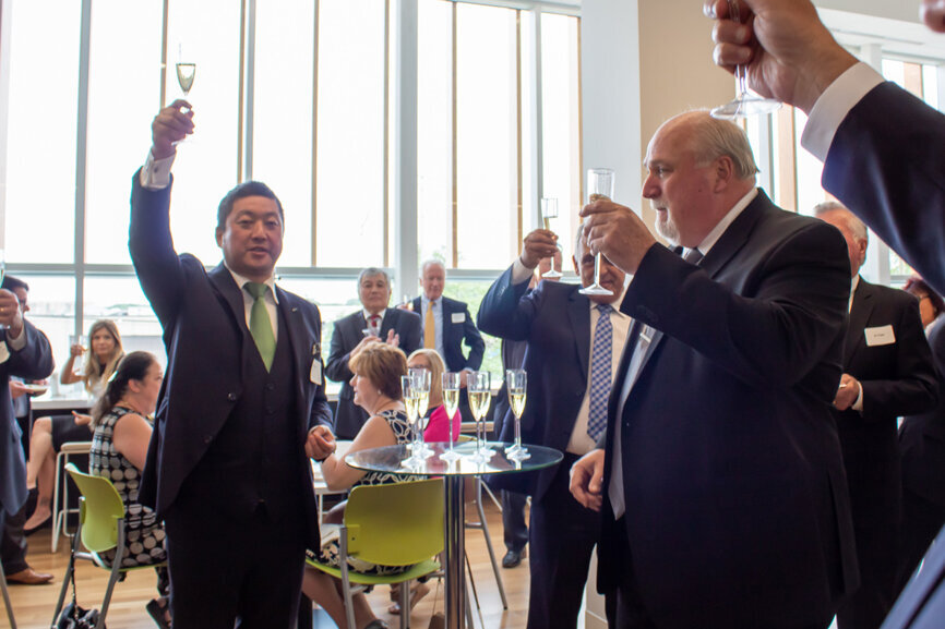 A champagne toast is offered by Mayor Ryan of Alsip, Ill., and Dr. Kiyotaka Nakao, during the dedication ceremony for the new GC America facility. (Photo: GC America)