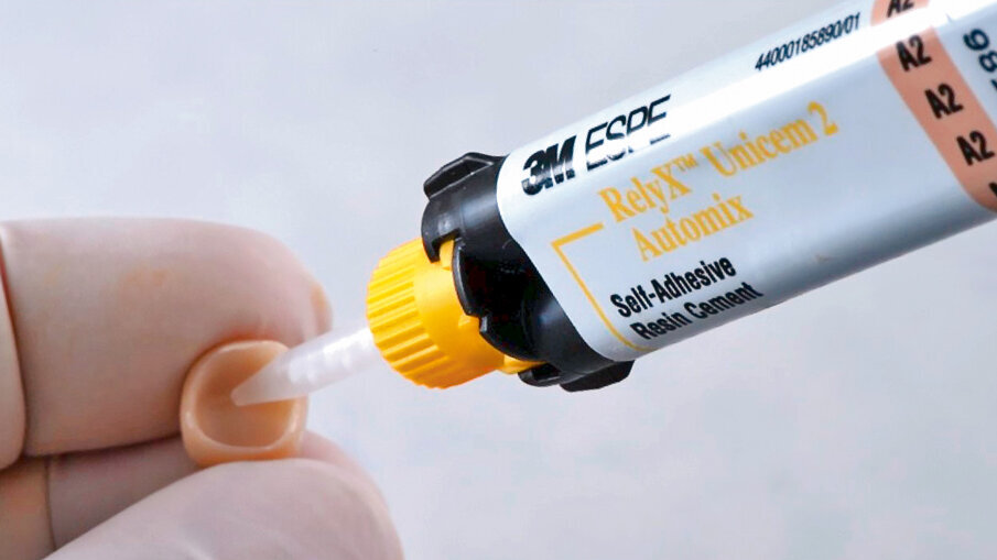 Fig. 10: Application of self-adhesive resin cement* into the crown. This proven product offers a simplified procedure since it eliminates the need for separate etching, priming and bonding.