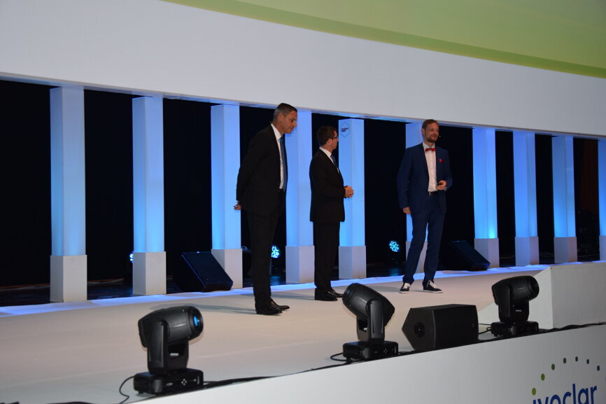 Ivoclar Vivadent representatives and a dental technician discussing the PrograMill range.