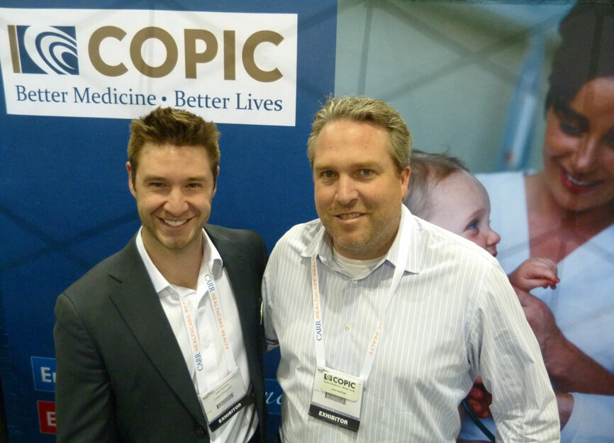 From left, Jeff Feakes and John Kaufman in the COPIC Financial booth. (Photo: Robert Selleck/Dental Tribune America)