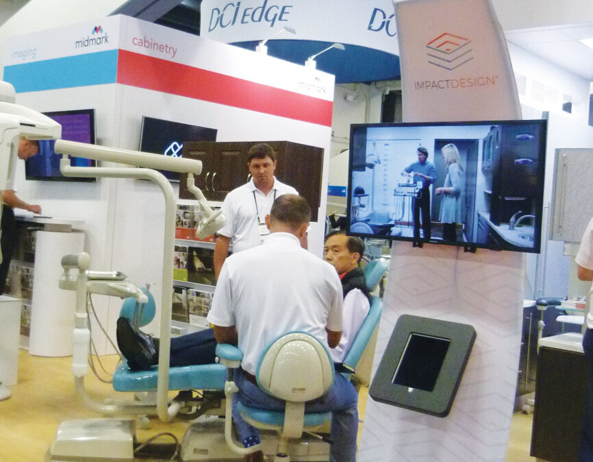 Chris Hebb of Midmark Corp. helps an attendee pick out equipment. (Photo: Sierra Rendon, DTA)