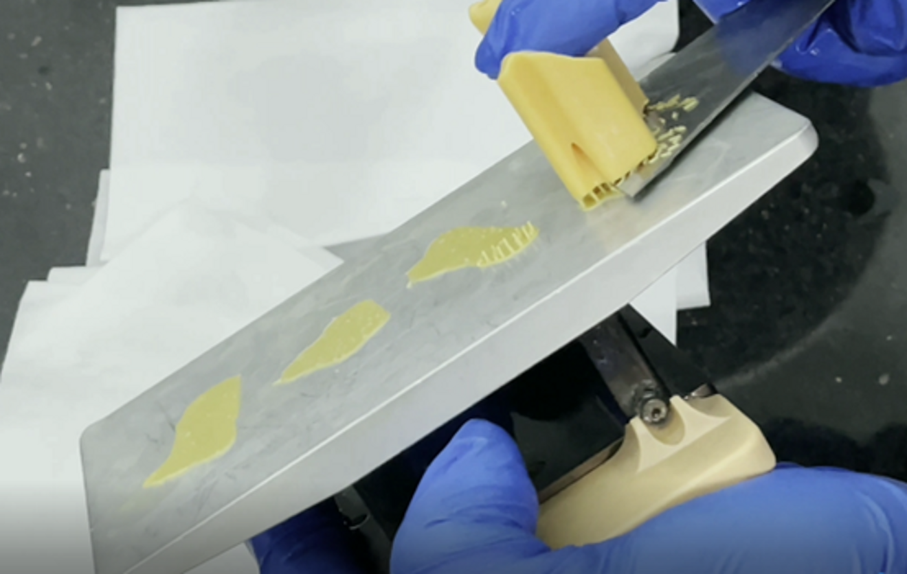 Fig. 10: Scooping the models off the printing platform.