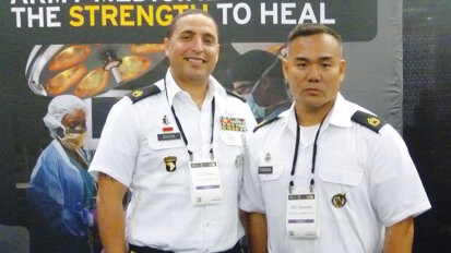 SSG Rivera and SFC Foronda stand at attention, ready to provide attendees the latest information on serving in the U.S. Army medicine team. (Photo: Sierra Rendon, DTA)