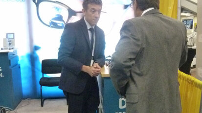 Designs for Vision’s Chris Gousios helps an attendee pick out the best lighting options.