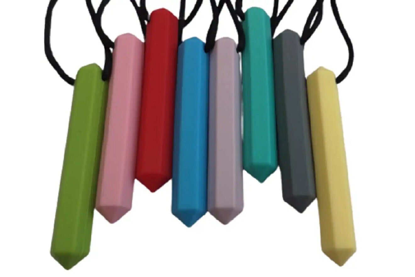 Figs. 10a & b: Silicone masticatory tools and cotton roll for masticatory cycle recovery training.