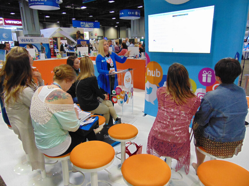 Meeting participants attend an educational presentation at PracticeGenius.