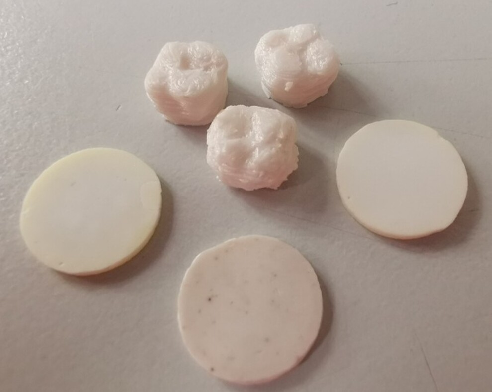 Experimental zirconia test specimens produced by direct ink writing, including tooth-like structures and discs prepared for mechanical and economic comparison with conventionally manufactured zirconia, as reported in the Dental Materials study.2 