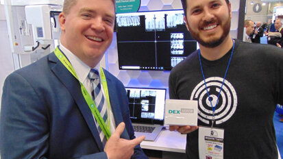 Eamon Knittel, left, and Ryan Hungate show off new sensor technology available from DEXIS at the Kavo Kerr booth. (Photo: Fred Michmershuizen/Dental Tribune America)
