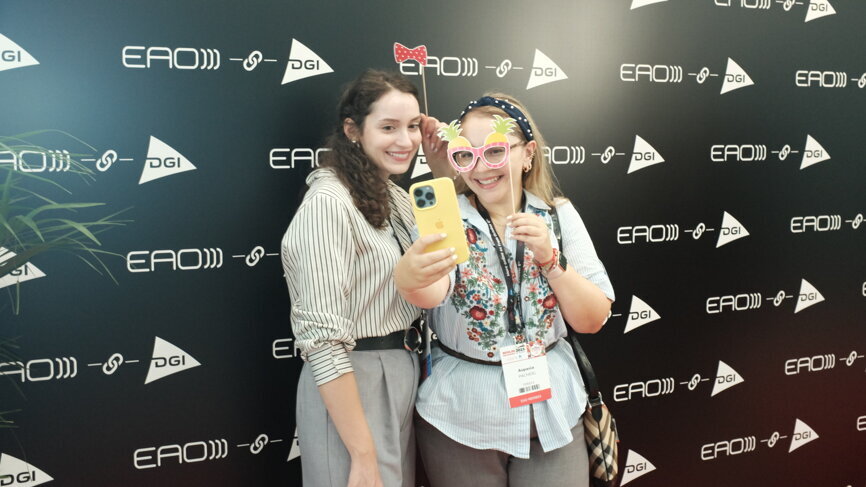 Attendees taking a selfie at the dedicated photo booth.
