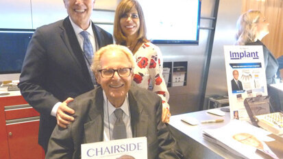 In the Glidewell Dental booth, Dr. Jack Hahn, seated, with Dr. Neil Park and Jennifer Archer.