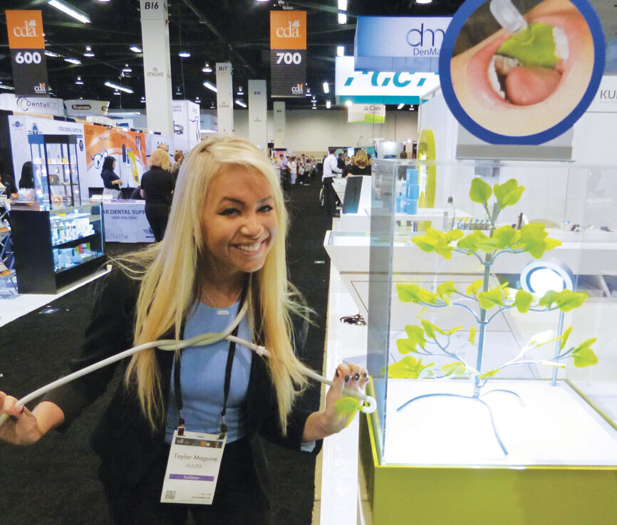 Taylor Maguire of Kulzer shows off the new Ivory ReLeaf, which is designed to assist with evacuation and retraction and maintains a dry field during dental procedures. 