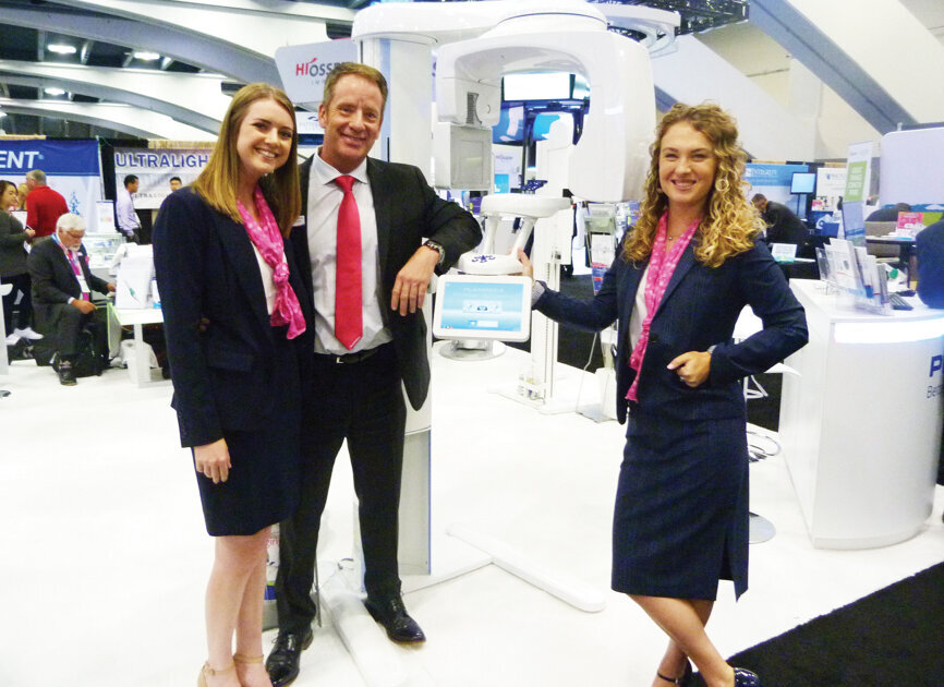 Steve Griffith and colleagues at the Planmeca USA booth highlight the benefits of the ProMax 3D unit. (Photo: Sierra Rendon, DTA) 