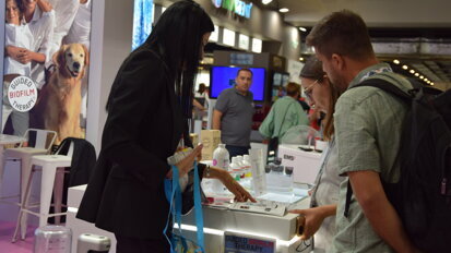 Participants engaging with the latest precision dentistry devices at the EMS booth.