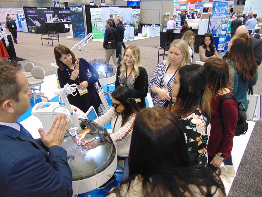 Meeting attendees learn about laser technology at Convergent Dental. (Photo: Fred Michmershuizen/Dental Tribune America)