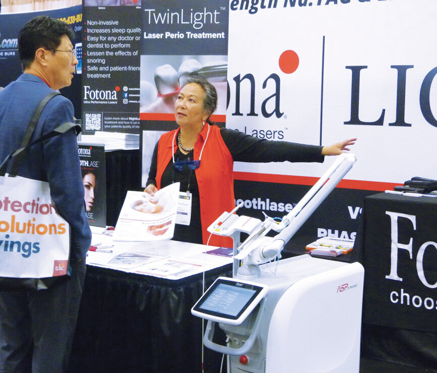 Tess Mandapat of Fotona helps an attendee. (Photo: Sierra Rendon, DTA)