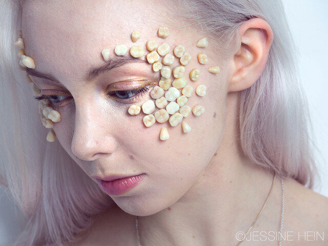 The artist herself wearing a tooth mask.