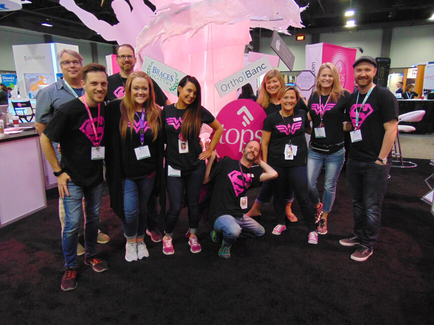 Wearing Wonder Woman and Superman t-shirts and handing out buttons with fun sayings on them, the folks at topsOrtho get into the company’s superhero theme. 