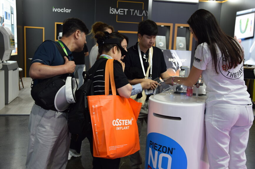 Participants engage with the latest product innovations at the EMS booth.