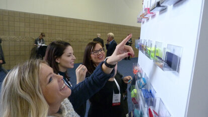 From left, Stacey Yocubets, chairside assistant; Kayla Benson, front office personnel; and Keri Tatum, front office personnel, all with the Just for Grins dental practice in Falcon, Colo., pick out some ‘Flair For Your Badge’ upon entering the exhibit hall at the 2019 Rocky Mountain Dental Convention. Their respective choices: ‘Tradeshow Diva,’ ‘Body by Bacon’ and ‘Somebody.’ (Photo: Robert Selleck/Dental Tribune America)