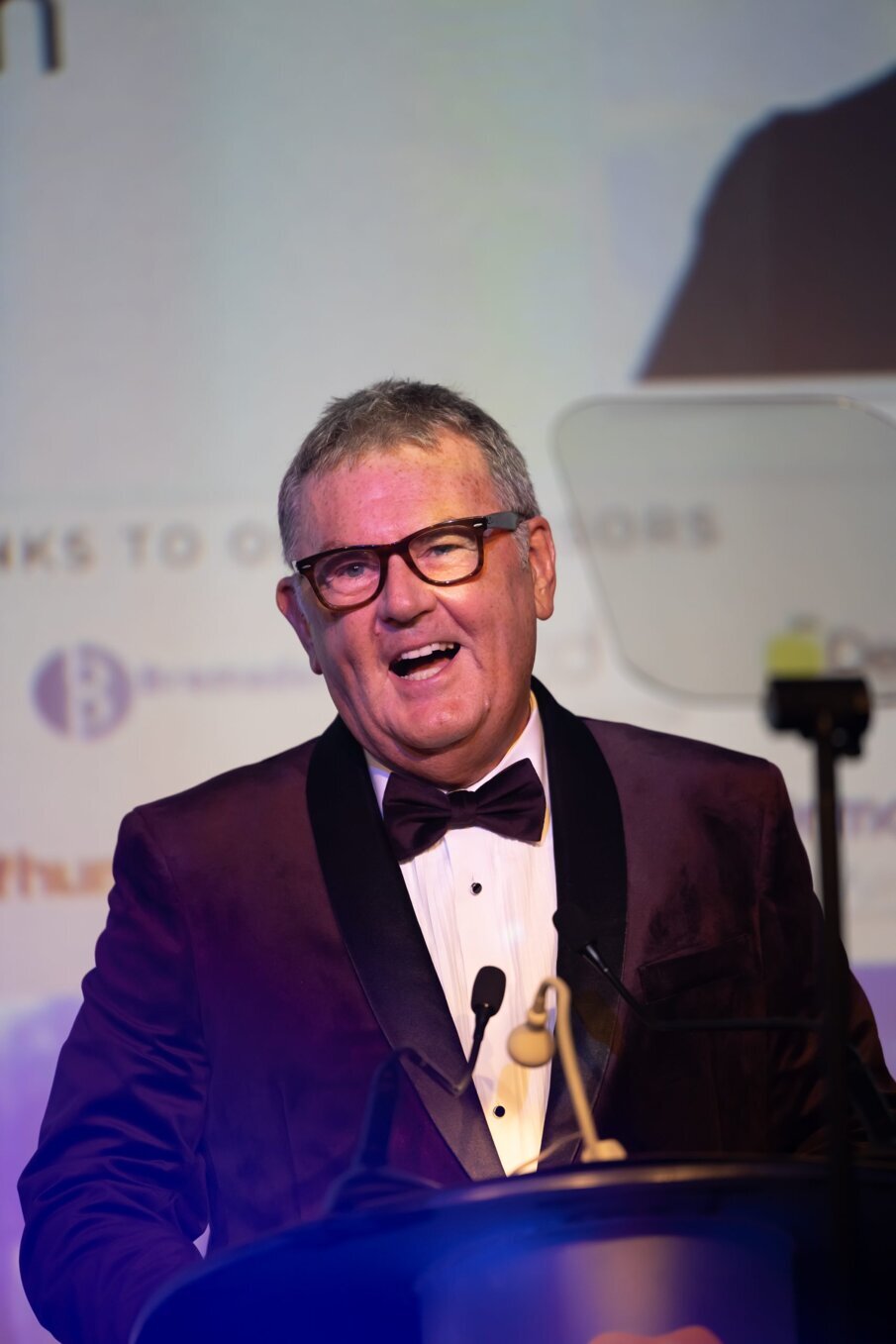 Prof Tipton giving speech on the stage of the Awards_