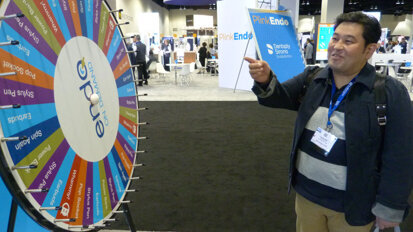 In the AAE Attendee Lounge, Daisuke Nagao, DDS, of Hitachinaka City, Japan, waits for the prize wheel to stop spinning (his prize: a pair of earbuds).