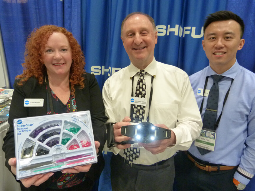 From left in the Shofu booth are Sarah Bermel with the Super-Snap composite polishing kit (course through to super-fine), David Goldshaw with the EyeSpecial C-III dental camera and Billy Ho. (Photo: Robert Selleck/Dental Tribune)