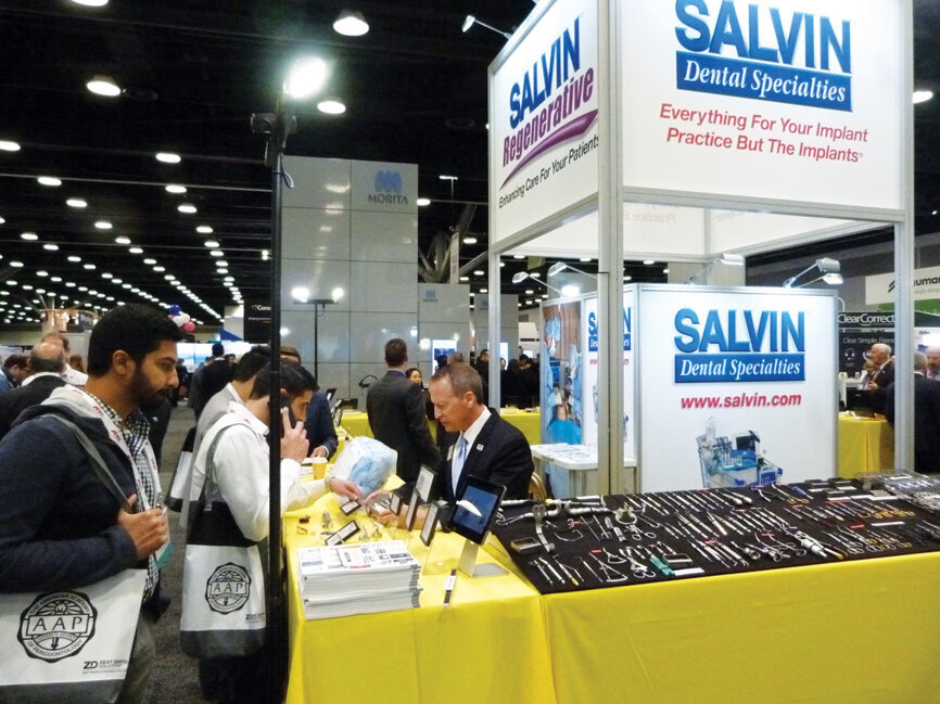 Jeff LoCricchio helps Dr. Navin Raju pick out products at the Salvin booth. (Photo: Sierra Rendon/DTA)