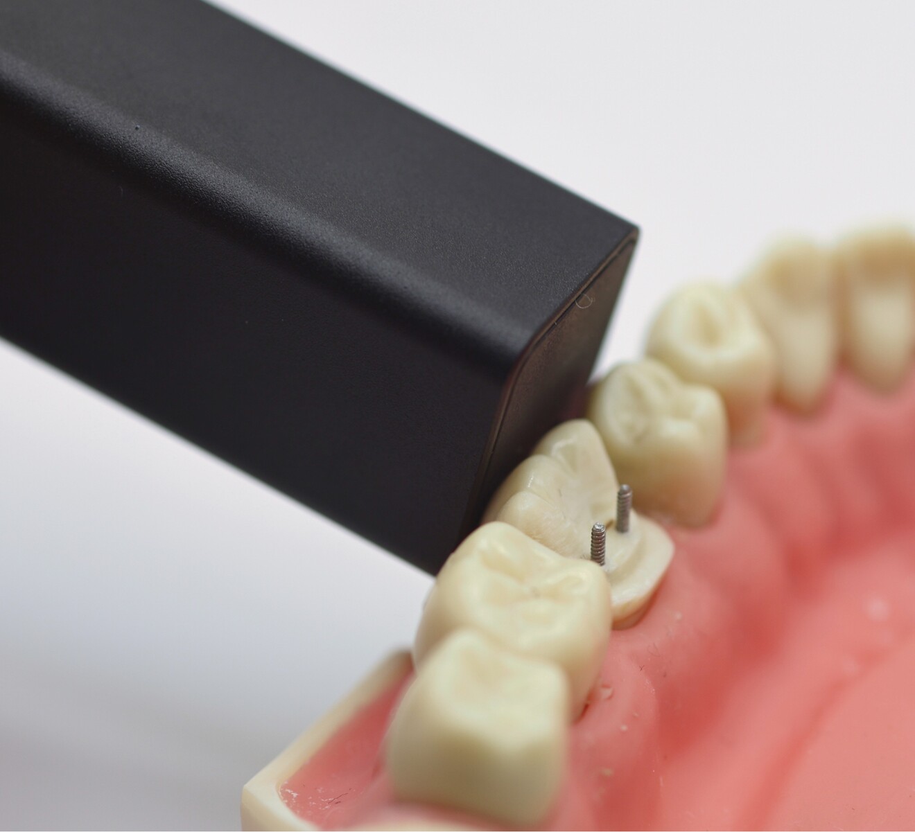Fig. 11: Bluetooth-connected sensor positioned on the dentoform tooth to assess and record the shade.
