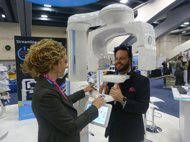 Kelly McGonigal and Jeremy Hiser of Planmeca model usage of the ProMax CBCT.