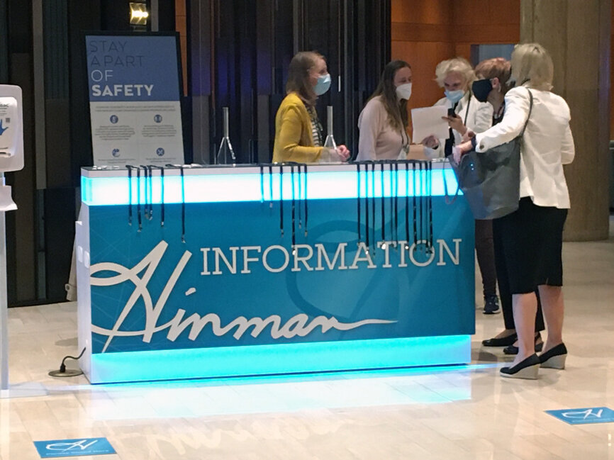 Everyone is wearing a mask when stopping for directions at the information booth.