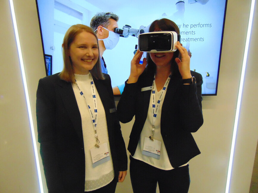 Christine, left, and Marie of Zeiss. Marie is wearing goggles that are part of the digital communication tools available with the Extaro 300 dental microscope. (Photo: Fred Michmershuizen/Dental Tribune America)