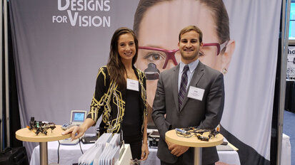 Need to update your loupes and headwear? Stop by the Designs for Vision booth, and get some help from Joanna Sterna and Phil Bullock. (Photograph by Nirmala Singh / Dental Tribune America)