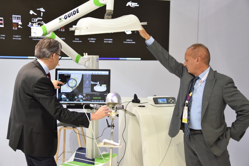 Together with Dr Kunz (left), X-Nan Co-Founder, President and CEO Ed Marandola demonstrated the X-Guide at the Nobel Biocare press conference. (Photograph: Monique Mehler, DTI)