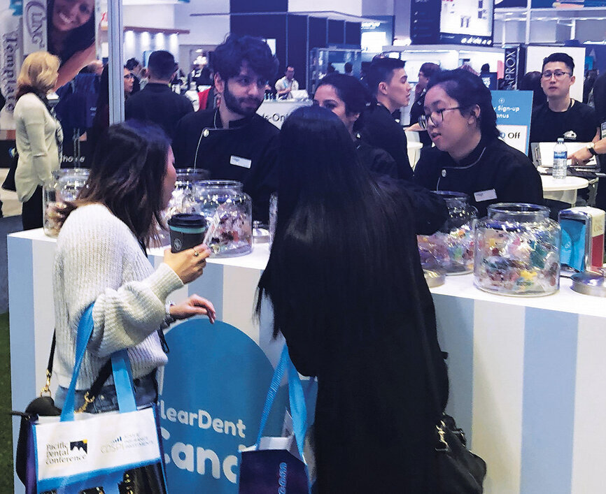 Attendees stop by the ClearDent booth for the candy bar but stay for the insights on digital practice-management.