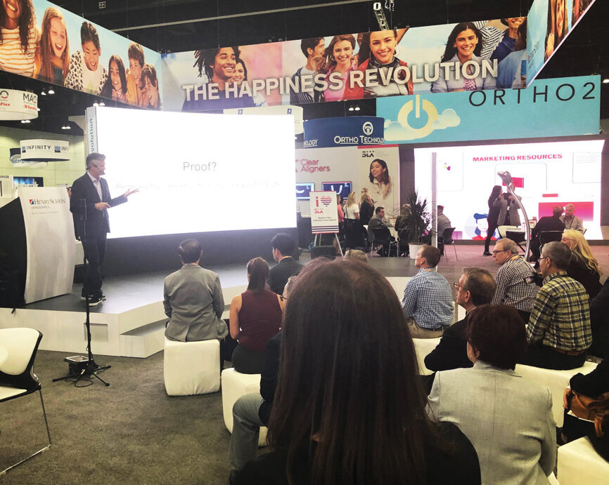 Dr. John Graham speaks on ‘SLX 3D: Self-Ligation Perfected’ at the Henry Schein Orthodontics booth. 