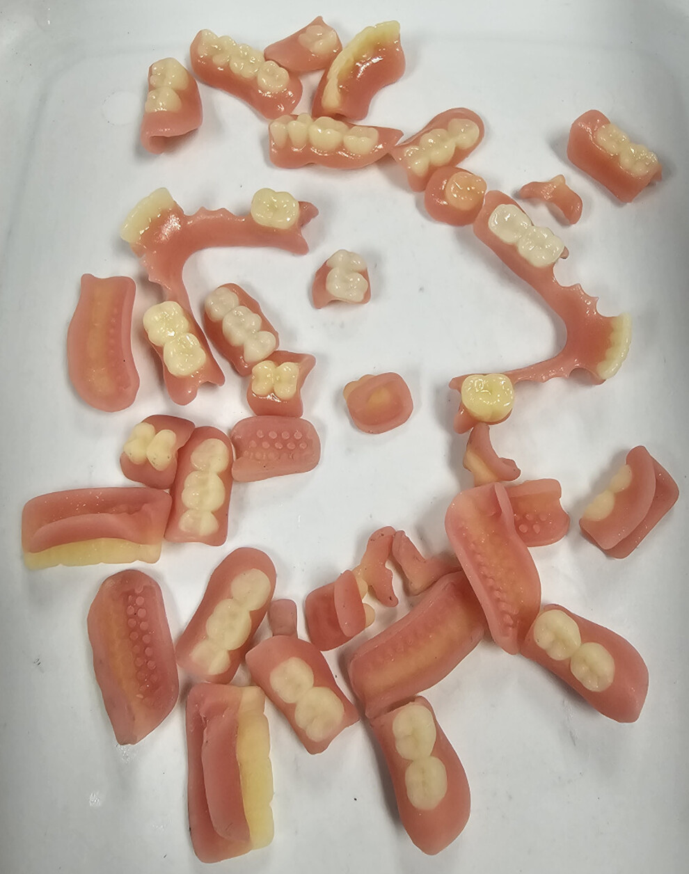  3D-printed resin parts of partial dentures.