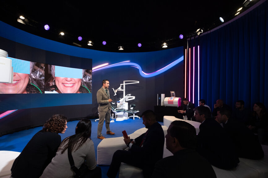 Dr Walter Renne giving a lecture titled “3-D printed smile design mock-ups” at the Planmeca booth. (Photograph: Robert Strehler, DTI) 
