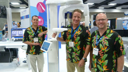 From left in the Planmeca booth, Neil Thomas, Steven Griffith and Brad Fine capture attention with their Hawaiian shirts and can show you how to capture incredibly detailed 2-D and 3-D images with the ProMax 3D Classic. (Photo: Robert Selleck/DTA)