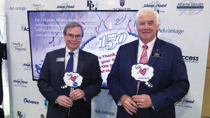 Tom Richardson, president of Atlanta Dental, left, and Gary Kirkus help celebrate the company’s 150 years of service.