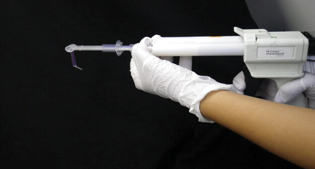 Fig. 7: The 3M™ Intra-oral Syringe is loaded from the hand-held gun but not yet activated.
