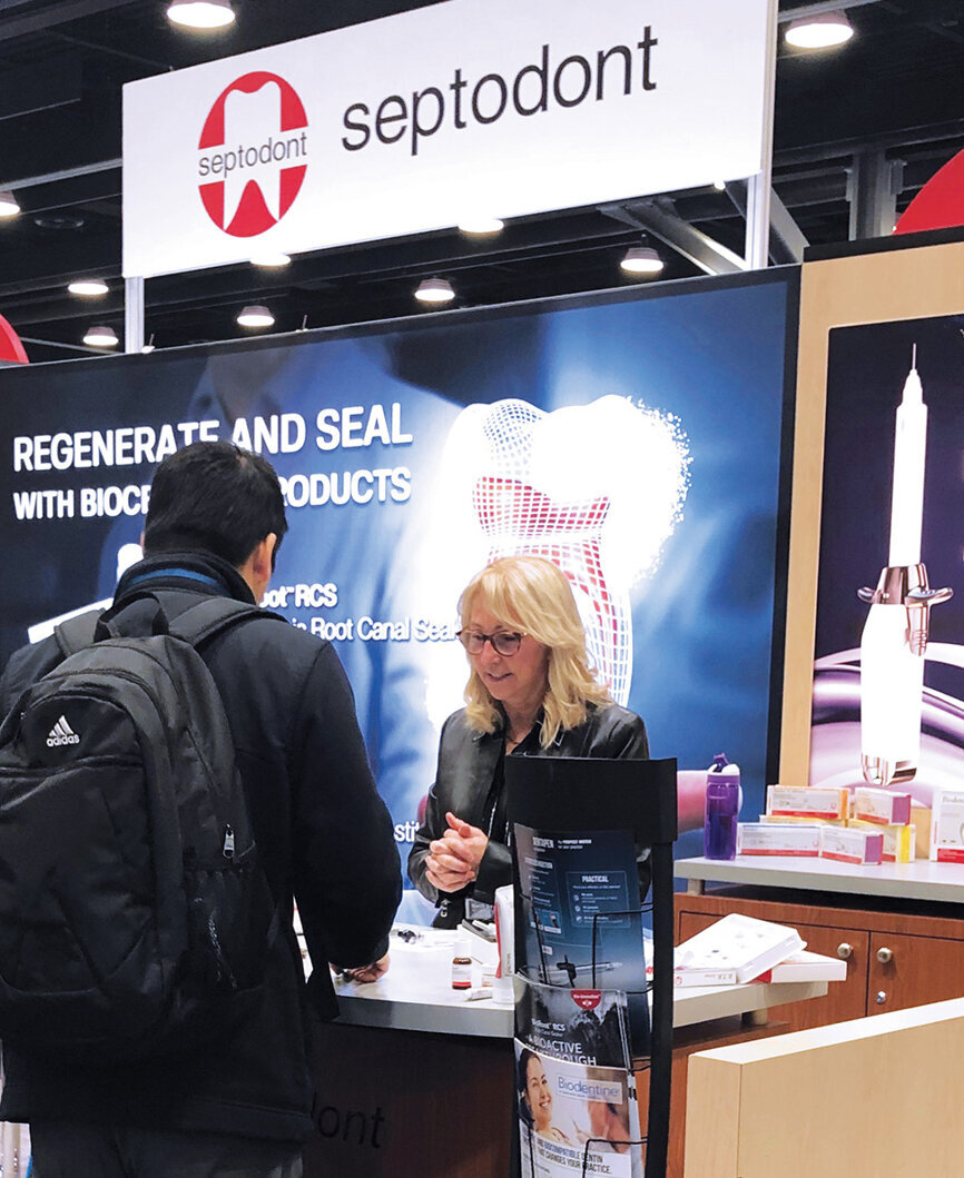 Suzanne Bourque of Septodont helps an attendee pick out new products.