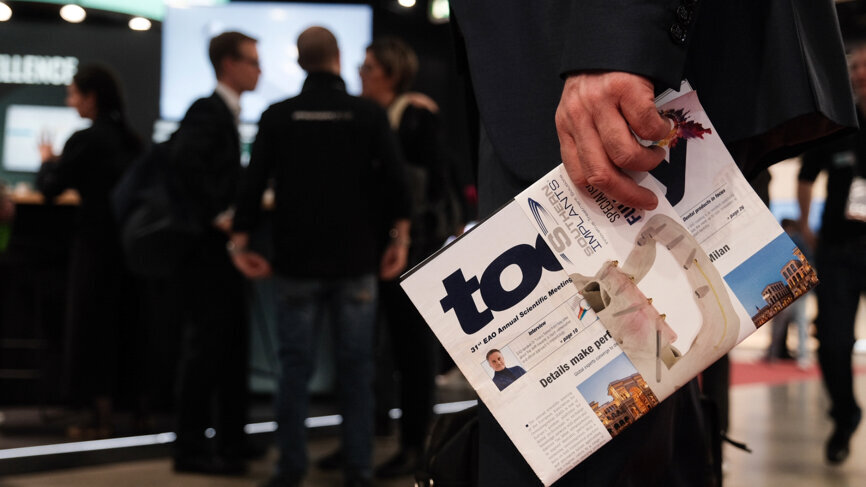 Participants keep abreast of daily developments at the conference through the DTI Today publication. 