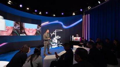 Dr Walter Renne giving a lecture titled “3-D printed smile design mock-ups” at the Planmeca booth. (Photograph: Robert Strehler, DTI)