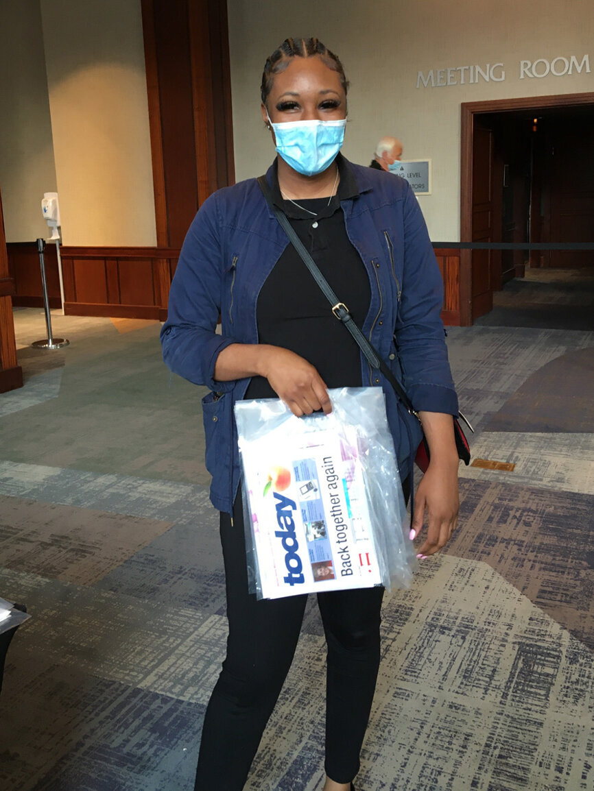 A distributor offers print copies of the ‘today’ newspaper. 