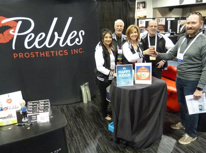 In the Peebles Prosthetics booth, Cindy Kelly, center, serves up a draw of New Belgium Brewing’s Fat Tire Amber Ale to retired dentist Dr. Paul Beer (not a typo) of Denver. To Kelly’s right are Letisia Solano and Peebles Founder and President Rick Peebles, CDT, and to her left is Steve Kelly. The booth taps a couple kegs of Colorado beers in the afternoons every year at the Rocky Mountain Dental Convention. (Photo: Robert Selleck/Dental Tribune America)