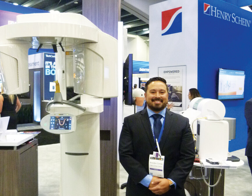 Brandon Correa, equipment sales specialist, at the Henry Schein booth. (Photo: Sierra Rendon, DTA)
