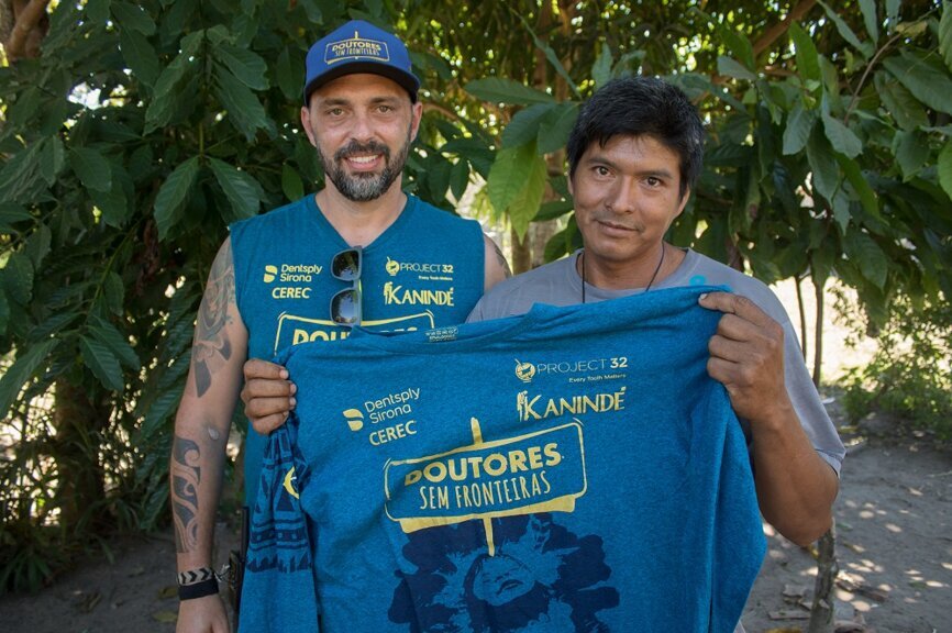 Dr. Caio Machado (left), who headed the expedition, is received by the village chief. (Photograph: Dentsply Sirona)