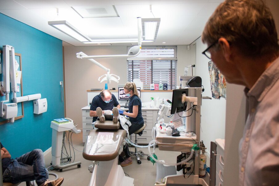 Tandarts-praktijkhouder Eric Kroese in actie in een behandelruimte van CBT Midden-Brabant.